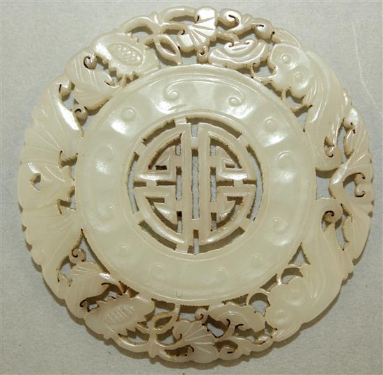 A Chinese pale celadon jade disc, 5.8cm